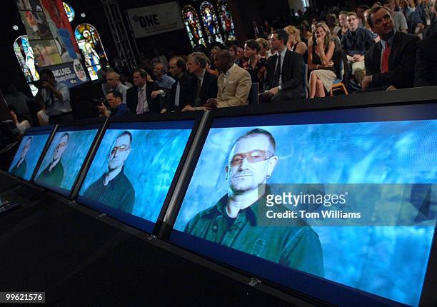 Bono makes a statement on a monitor during the launch of ONE Vote '08, a non-partisan effort to energize presidential candidates to fight global...