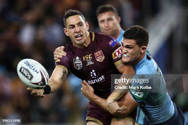 Billy Slater of Queensland passes as he is tackled by Nathan Cleary of the Blues during game three of the State of Origin series between the...