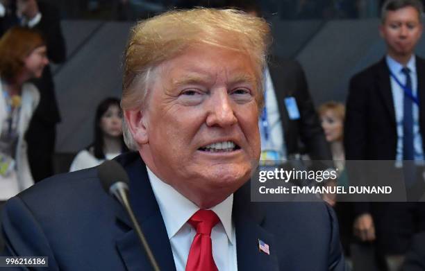 President Donald Trump looks on after arriving for the North Atlantic Council meeting on the sidelines of NATO summit, at the NATO headquarters in...