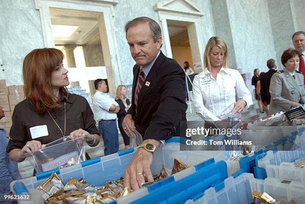 Rep. Chet Edwards, D-Texas, makes a care package to be sent to troops in Iraq, Afghanistan, and other locations, as part as effort by the USO...