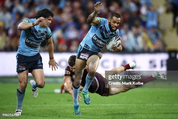 James Roberts of the Blues watches on as Josh Addo-Carr of the Blues beats the tackle of Corey Oates of Queensland during game three of the State of...