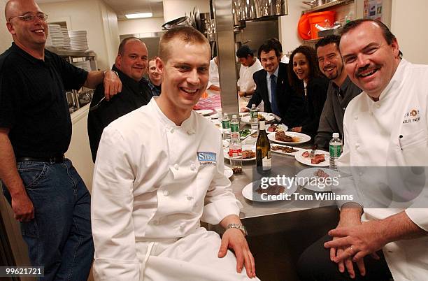 Members of the Charile Palmer Steak restaurant team including chef Bryan Voltaggio, center, and Charlie Palmer himself, right, take a break while...