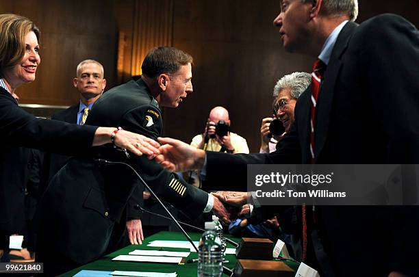 Gen. David Petraeus talks with Sen. Daniel Akaka, D-Hawaii, before a hearing of the Senate Armed Services Committee on his nomination for...