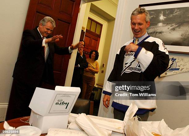 Rep. Robert Brady, D-Pa., left, pays of a bet of cannolis and cheese steaks from Philadelphia to Rep. Jim Davis, D-Fla., Monday. The Tampa Bay...