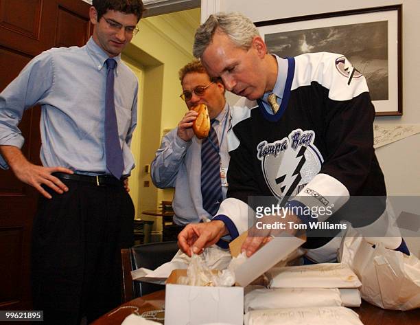 Rep. Jim Davis, D-Fla., right, and his staff collect on a bet by Rep. Robert Brady, D-Pa., of a bet of cannolis and cheese steaks from Philadelphia...