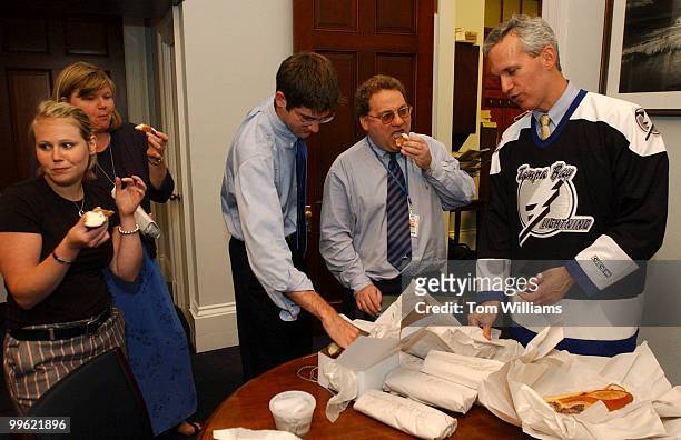 Rep. Jim Davis, D-Fla., right, and his staff collect on a bet by Rep. Robert Brady, D-Pa., of cannolis and cheese steaks from Philadelphia on Monday....