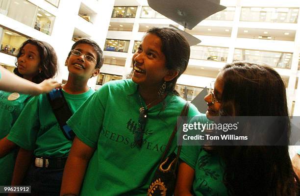 Radha Sampath Kumar center, and Aneesha Shah right, both of India, laugh with peers of Indians and Pakistanis that make up in Seeds for Peace before...