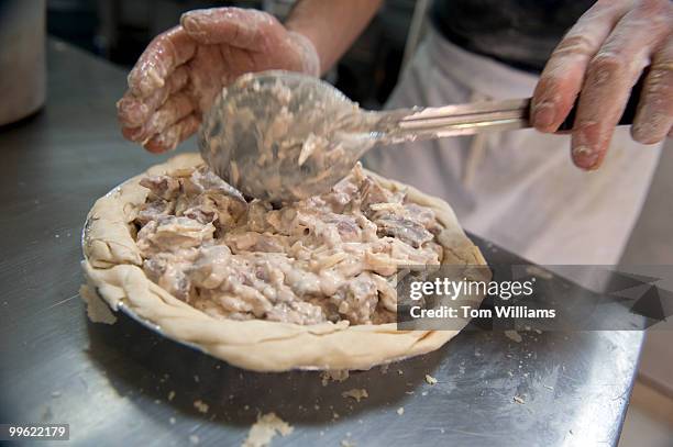 Stevie McKeever, makes a Steak Mushroom Onion and Gruyere pie in the kitchen of Dangerous Pies on H Street, NE, April 5, 2010.