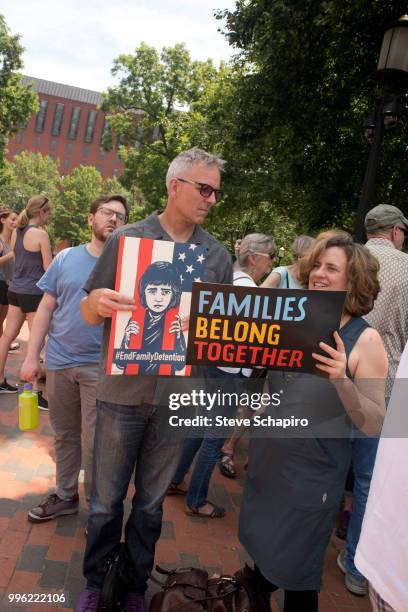 View of a pair of demonstrators, both with signs, during a rally against the Trump administration's immigration policies, Washington DC, June 27,...