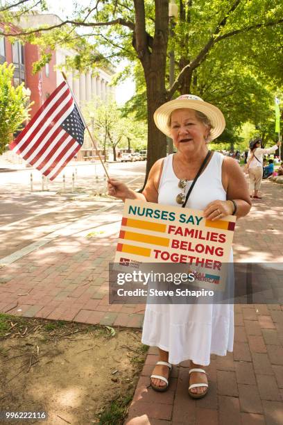 Portrait of a demonstrator during a rally against the Trump administration's immigration policies, Washington DC, June 27, 2018. She is holds an...