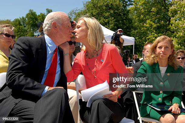 Nancy Baker kisses her father-in-law former Secretary of State James Baker, at a news conference focusing on pool safety and honoring the memory of...