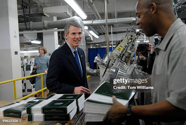 Office of Management and Budget Director Rob Portman, talks with Government Printing Office employee Jeffrey Hayden while copies of The Budget of the...