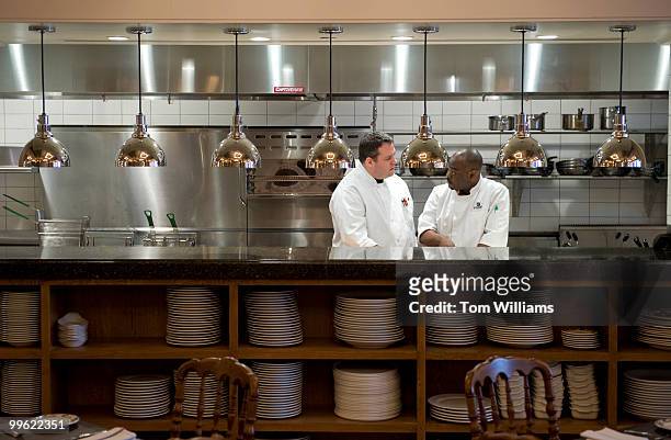 Anthony Acinapura, left, chef of Potenza, located at 15th and H Sts., NW, talks with sous-chef Serge Karmen in the restaurant's kitchen, March 18,...