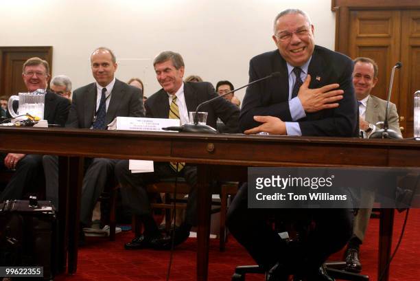 Secretary of State Colin Powell, shares a laugh with members of his staff during the House Appropriations Committee hearing on the State Department...