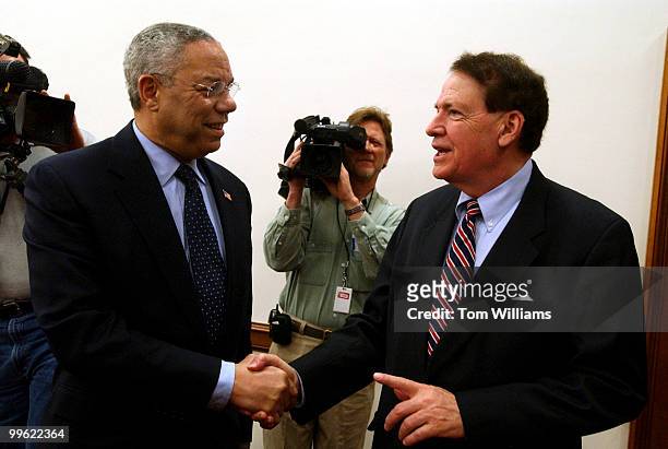 Secretary of State Colin Powell, talks with Rep. Charles Taylor, R-N.C., before a House Appropriations Committee hearing on the State Department...