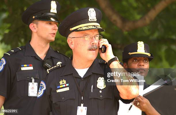 Capitol Police Chief Terrance Gainer, talks on his cell phone and makes preparations for the arrival of, former president Ronald Reagan, on the West...