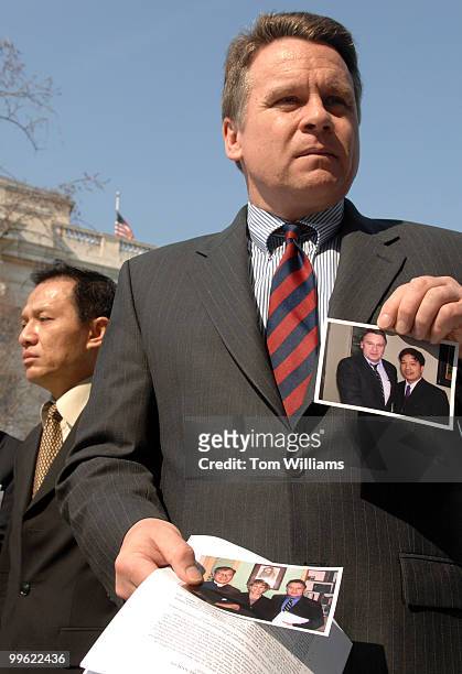 Rep. Chris Smith, R-N.J., holds a picture of Vietnamese political prisoner Father Nguyen Van Ly who he met with in December 2005, but is now...