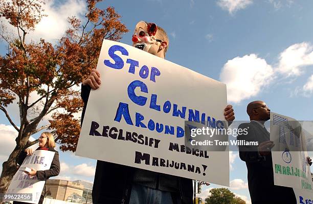 Scott Morgan, of stopthedrugwar.org, center, Michael McFadden, of maps.org, right, and Trina Zahller, of Criminal Justice Policy Foundation, protest...