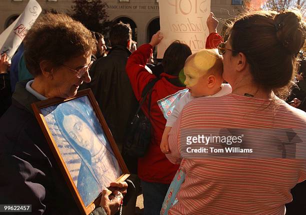 Florence Pasco of Reading, Pa., says hello to Joseph Weidner, 6 months, and his mother Lisa of Hamburg, Pa., at a protest by relgious groups opposing...