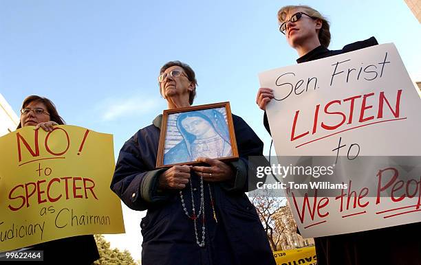 From left, Angela Clark, Florence Pasco, and Sharon DePoorter, hold sings at a protest by relgious groups opposing the nomination of Sen. Arlen...