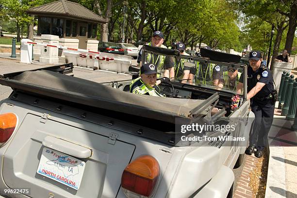 Capitol Police move the car of Sen. Richard Burr, R-N.C., during a protest by ADAPT, an activist group for people with disabilities, on Constitution...