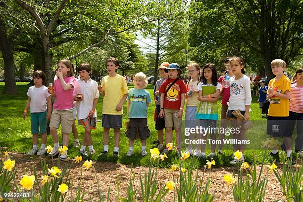 Children watch the arrest of ADAPT protesters, an activist group for people with disabilities, on Constitution Avenue, April 28, 2009. The group was...