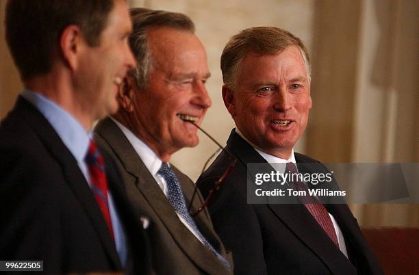 Former Vice President Dan Quayle, left, talks with former President, George Bush, and Sen. Bill Frist, R-Tenn., at an unveiling ceremony for a bust...