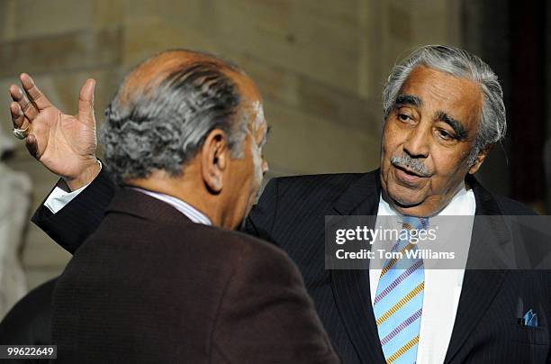 Rep. Charlie Rangell, D-N.Y., right, speaks with Rep. John Conyers, D-Mich., before a reception in Statuary Hall to recognize his Rep. John Dingell,...