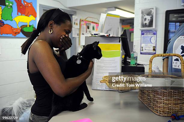 Kisha Parker breaks down as she prepares to hand over her cat "Smoky" that she has owned for 7 years, at the DC Animal Shelter on New York Ave., NE,...