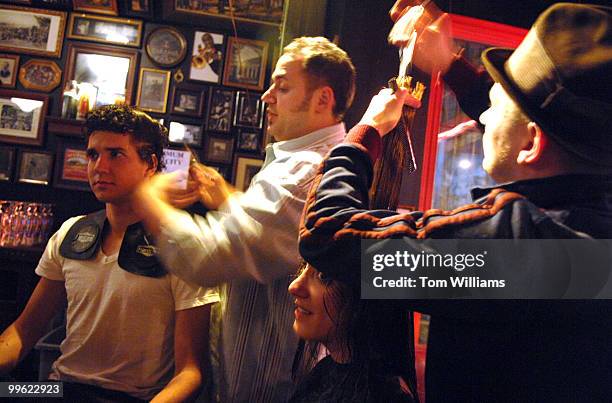 Stylist John Cullen works on the hair of Liz Lapon on her 30th birthday at the Red and the Black bar on H street, NE. Laurent Chauvex works on the...