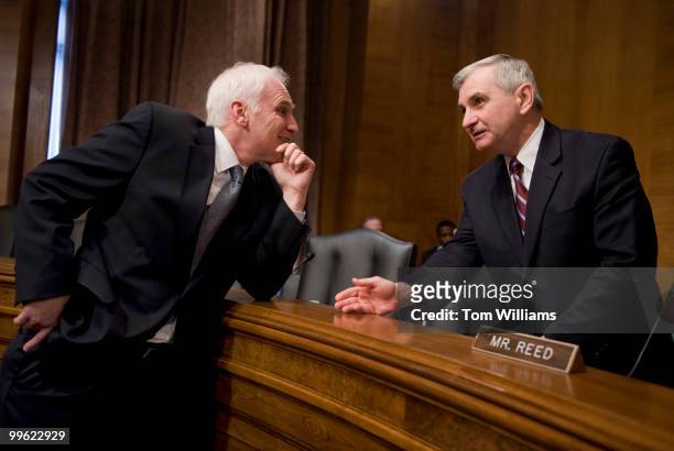 Daniel Tarullo, left, a member of the Federal Reserve Board of Governors talks with Sen. Jack Reed, D-R.I., before a Senate Banking, Housing and...