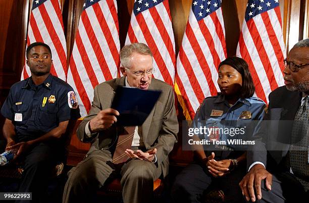 Senate Minority Leader Harry Reid, D-Nev., with Cpt. Derreck Lea of the Prince George's County Fire Dept., after a meeting with first responders from...