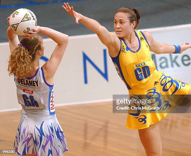 Jacqui Delaney of the Thunderbirds looks to pass over Swifts attacker Alison Broadbent in action during the Commonwealth Bank Trophy Netball Grand...