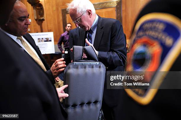 Jose Vazquez, left, Department of Homeland Security, shows Sen. Bernie Sanders, I-Vt., a prototype of a self-contained breathing apparatus to be used...