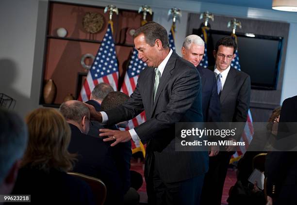 House Minority Leader John Boehner, R-Ohio, jokes with a reporter after a news conference with Conference Chairman Mike Pence, R-Ind., center, and...