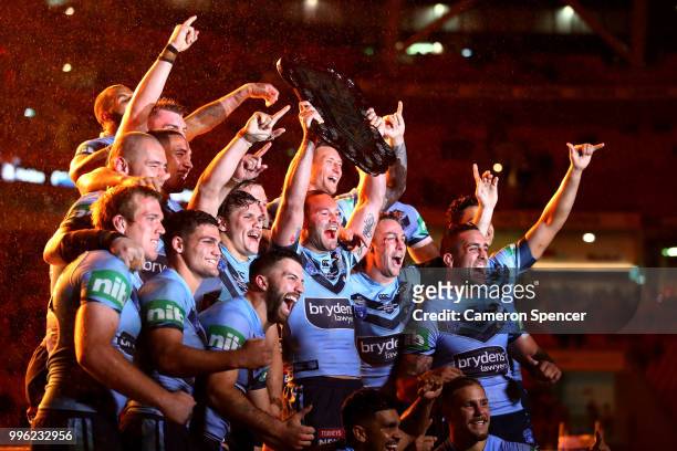 Boyd Cordner of the Blues and team mates celebrate with the trophy after winning the series following game three of the State of Origin series...