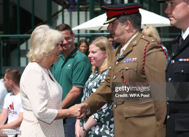 Camilla, Duchess of Cornwall is greeted by Major Alan McTaggart as she attends attends day nine of the Wimbledon Lawn Tennis Championships at All...