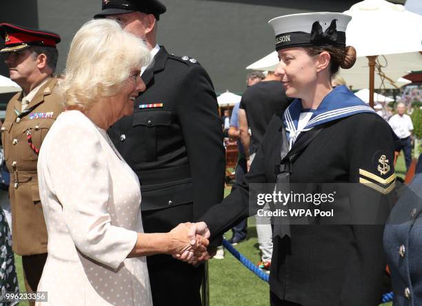 Camilla, Duchess of Cornwall meets service personnel as she attends day nine of the Wimbledon Lawn Tennis Championships at All England Lawn Tennis...