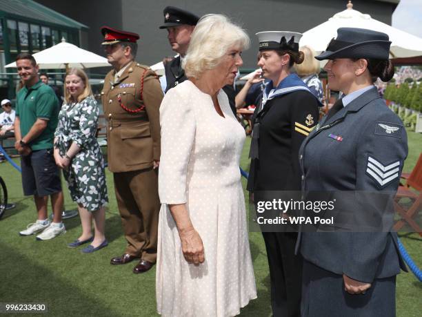 Camilla, Duchess of Cornwall meets Sergeant Kelly Griffith as she attends day nine of the Wimbledon Lawn Tennis Championships at All England Lawn...