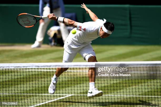 Kei Nishikori of Japan plays a backhand slice against Novak Djokovic of Serbia during their Men's Singles Quarter-Finals match on day nine of the...