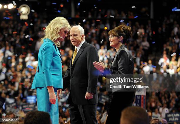 Sen. John McCain walks the stage with his wife Cindy, left, and his running mate Gov. Sarah Palin, after he accepted the Republican nomination for...
