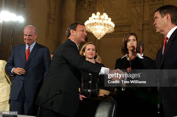 Judge John G. Roberts Jr., center, shakes hands with Senate Majority Leader Bill Frist, R-Tenn., after Roberts first day at the Senate Judiciary...