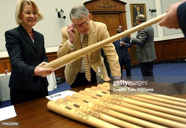 Rep. Martin Sabo, D-Minn., checks out Louisville Slugger bats with his executive assistant, Bonnie Gottwald, after check presentation ceremony for...