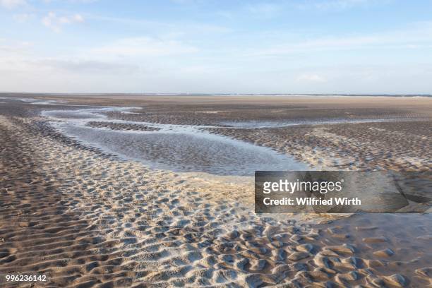 low tide in the lower saxon wadden sea national park, langeoog island, east frisia, north sea coast, lower saxony, germany - langeoog stock pictures, royalty-free photos & images
