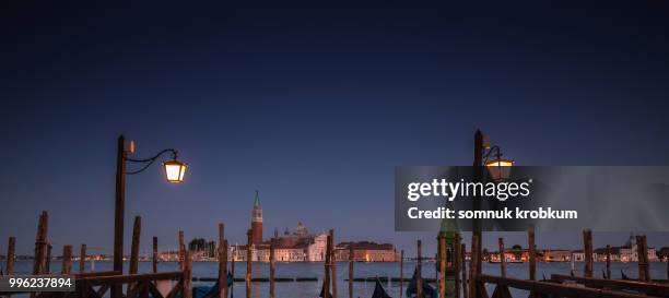 boat port at venice in twilight time in summer - somnuk krobkum stock-fotos und bilder