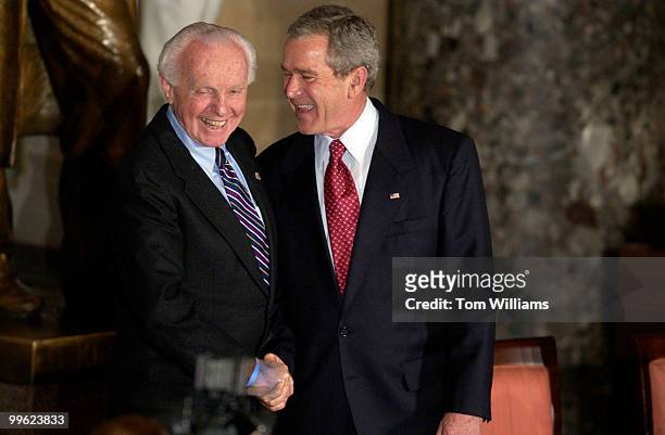President George W. Bush, right, shakes hands with Rep. Tom Lantos, D-Calif., after an event in Statuary Hall celebrating the 50th anniversary of the...
