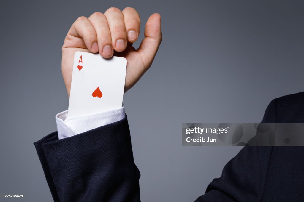 Man is hiding an Ace in the sleeve