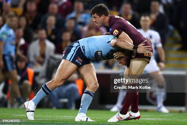 Tariq Sims of the Blues and Ben Hunt of Queensland scuffle after a play the ball during game three of the State of Origin series between the...