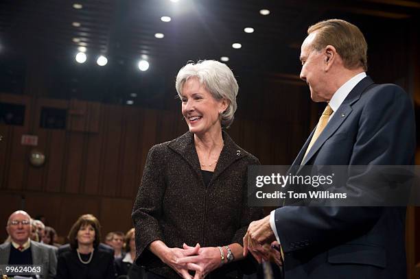 Kathleen Sebelius, nominee for Secretary of Health and Human Services, arrives with former Sen. Bob Dole, R-Kan., before her conformation hearing in...