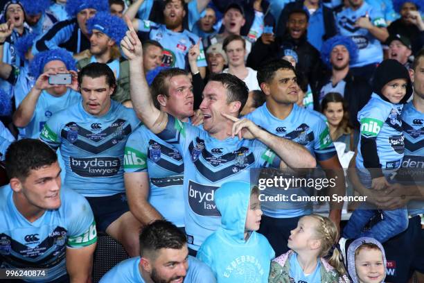 James Maloney of the Blues celebrates with fans after winning the series following game three of the State of Origin series between the Queensland...